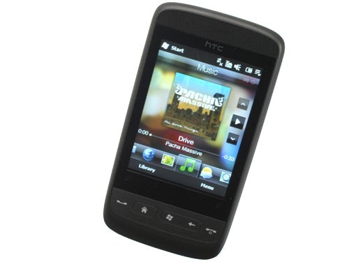 HTC Touch2 smartphone with music player on screen.