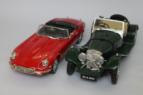 Two vintage model cars photographed on a white background.