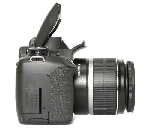 Canon EOS 500D DSLR camera with lens on white background.