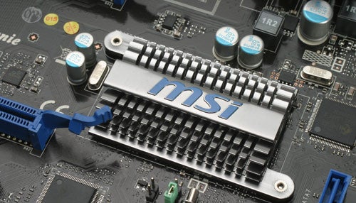 Close-up of MSI P55-GD65 Motherboard with heatsink and capacitors.