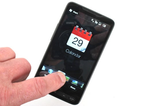 Hand holding an HTC HD2 smartphone displaying the calendar.
