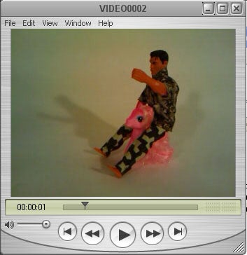Video player interface displaying a toy ride-on unicorn with a person.