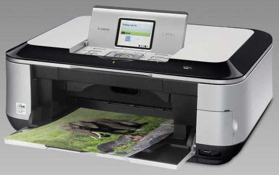 Canon PIXMA MP640 printer with printed photo emerging.