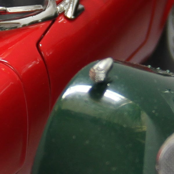Close-up of a red Canon EOS 7D camera detail.