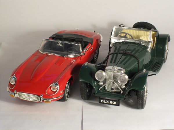 Toy model cars on display with white background