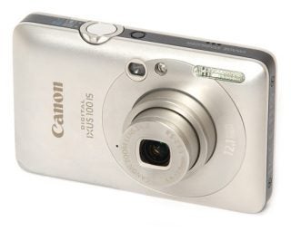 Canon Digital IXUS 100 IS compact camera on white background.