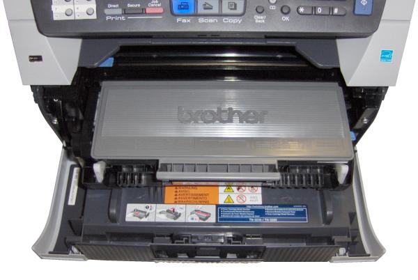 Brother MFC-8380DN printer open showing toner cartridge and controls.