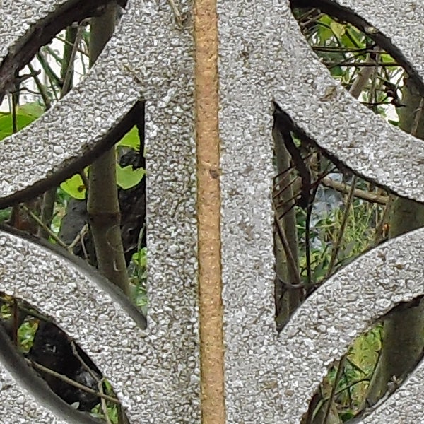 Close-up of a decorative metal wheel with a mosaic pattern.