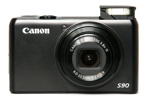 Canon PowerShot S90 compact camera with flash up.