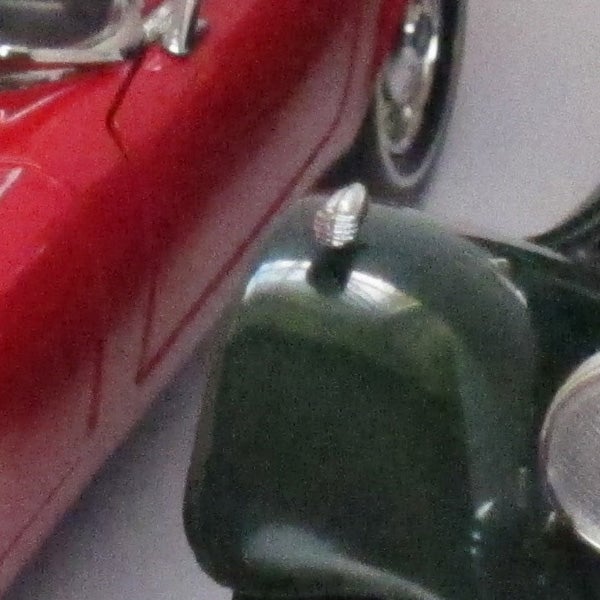 Close-up photo of a toy motorcycle with a background.