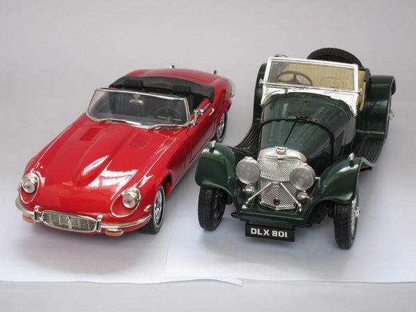 Two vintage model cars on a white background
