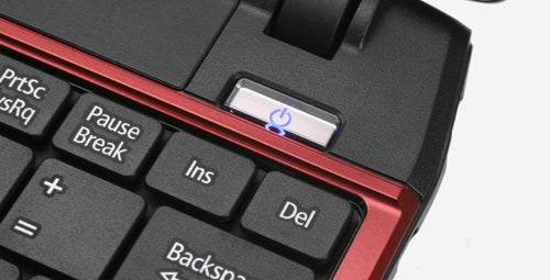 Close-up of Acer Aspire laptop power button and keyboard.