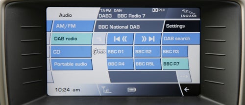Jaguar XKR Coupe's infotainment system displaying radio stations.