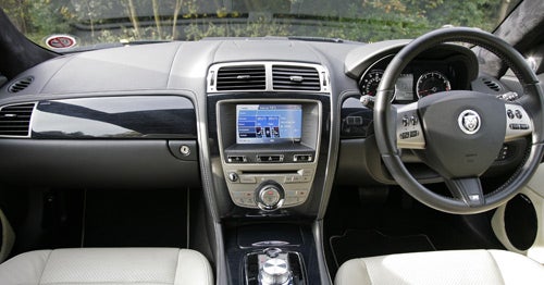 Interior view of Jaguar XKR Coupe showing dashboard and steering wheel.