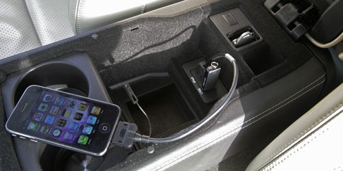 Smartphone connected to Jaguar XKR Coupe's interior USB port.