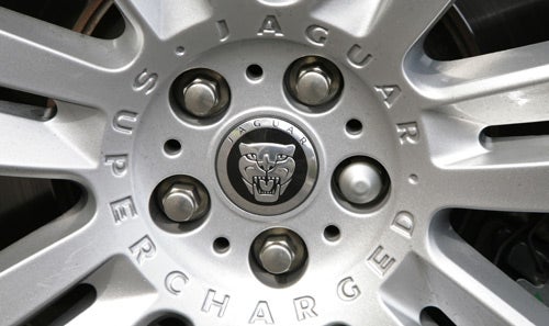 Close-up of Jaguar XKR wheel with Supercharged badge.