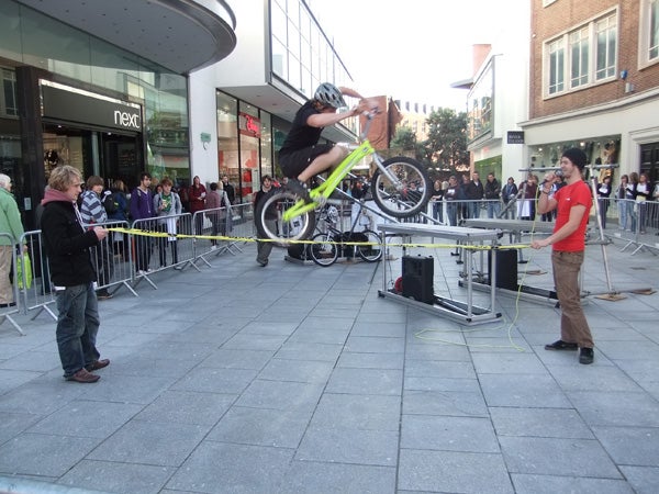 Bike stunt demonstration in an urban outdoor setting
