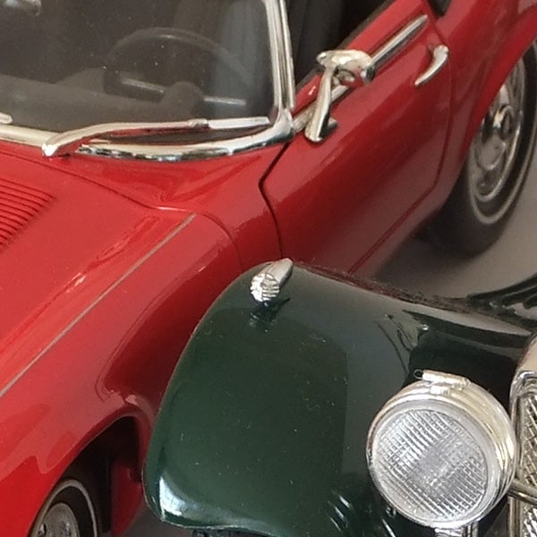 Close-up of red and green diecast model cars