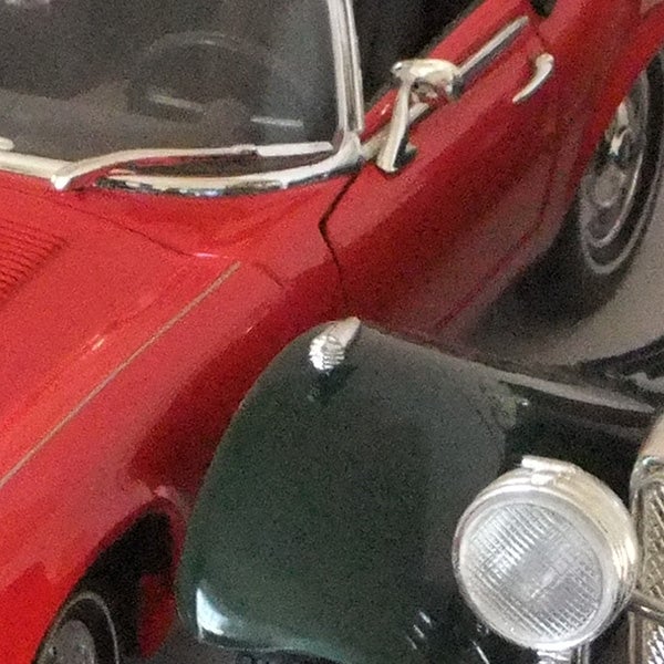 Close-up of a red vintage car model with focus issue