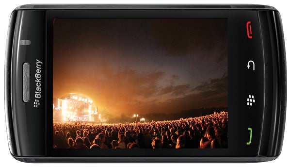 BlackBerry Storm2 9520 smartphone displaying concert photo.