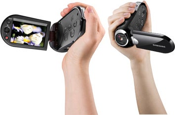 Hands holding Samsung SMX-C10 camcorder, displaying LCD screen.