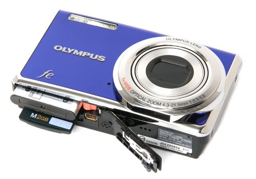 Olympus FE-5020 camera with open memory card slot.