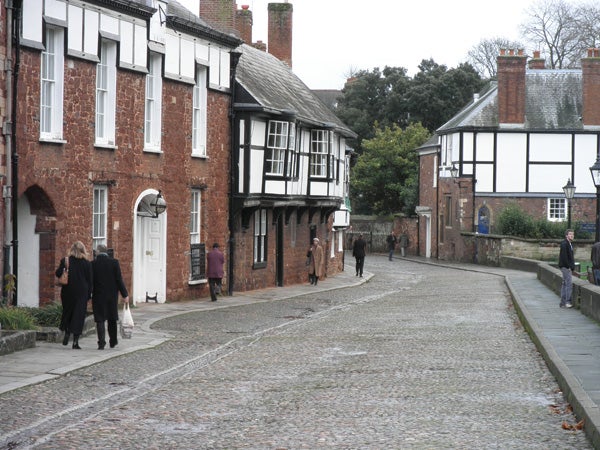 Photograph of a cobblestone street with historic buildings.
