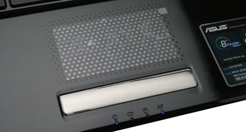 Close-up of Asus UL50Vg laptop speaker and status indicators.