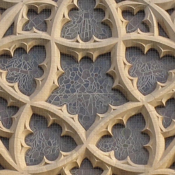 Close-up of a gothic stone window tracery with intricate design.