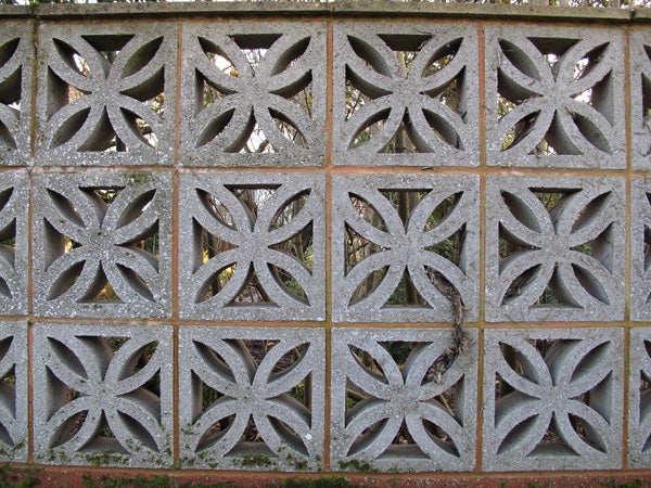 Decorative concrete block wall with star patterns.