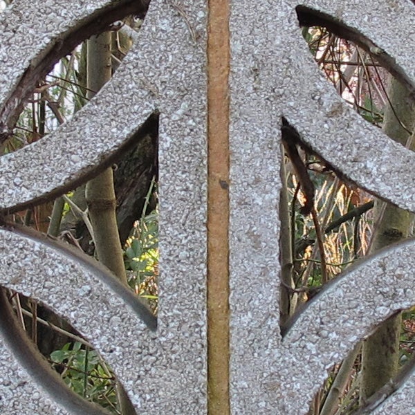 Close-up of intricate ironwork with natural background bokeh.