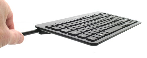 Slim keyboard connected to Asus EeeTop PC from a side view.