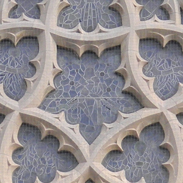 Intricate stone tracery patterns on cathedral facade.