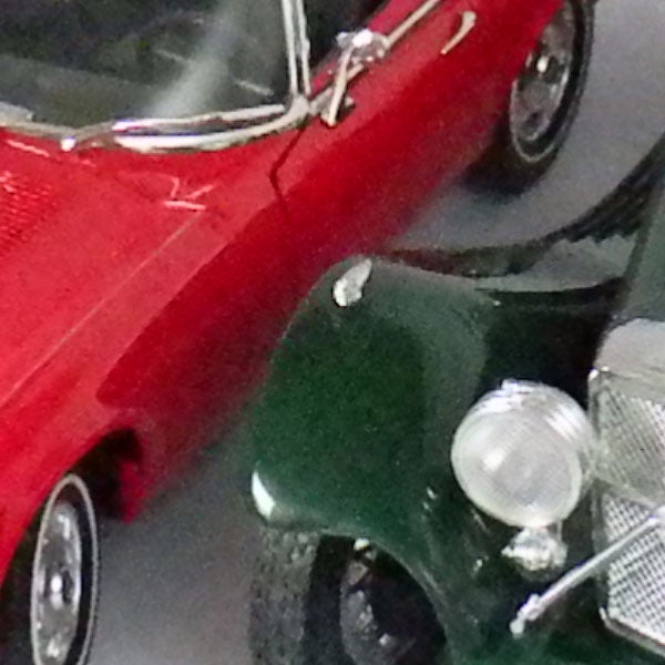 Toy model cars with red and green vehicles.