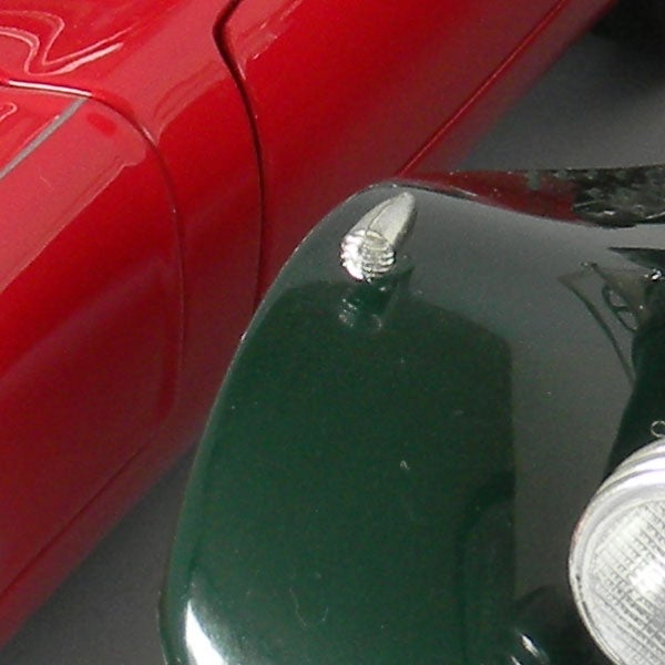 Close-up of a classic red and green car models.
