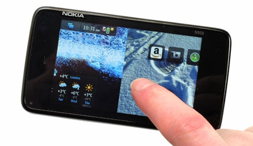 Person using the touchscreen of a Nokia N900 smartphone.