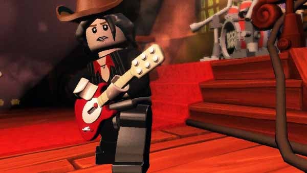 Lego minifigure character playing guitar on stage.
