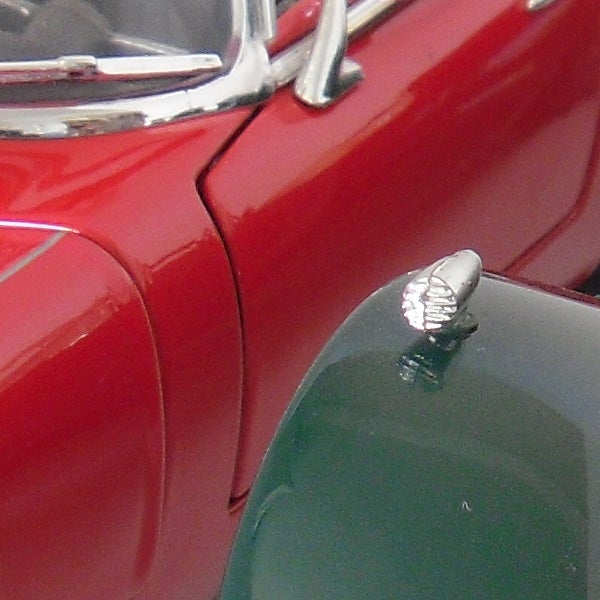 Close-up of classic car hood ornaments and details.