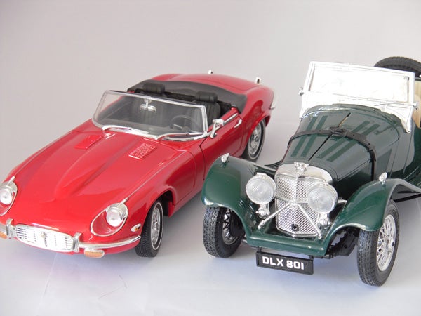 Two vintage model cars displayed on white background