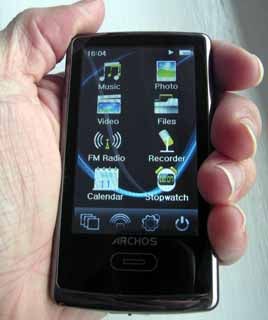 Hand holding an Archos 3 Vision media player.