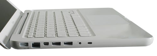 Side view of a 2009 Apple MacBook showing keyboard and ports.