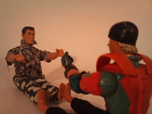 Action figures posed in a mock fight scene.