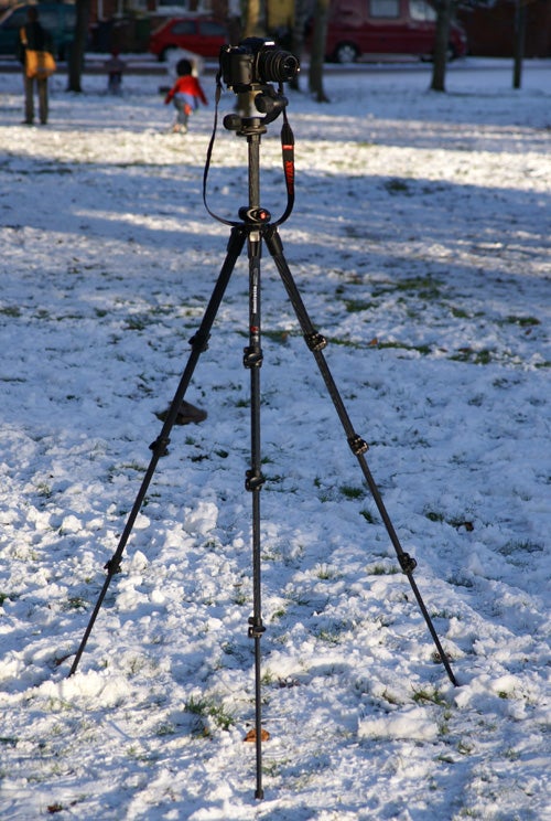 Manfrotto 190CXPRO4 tripod with camera on snowy ground.