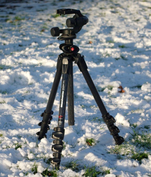 Manfrotto 190CXPRO4 carbon fiber tripod standing on snowy ground.