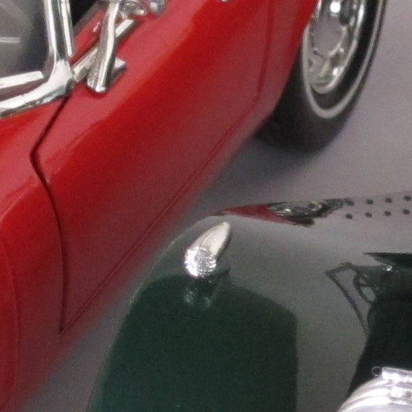 Close-up of a red toy car's front side.