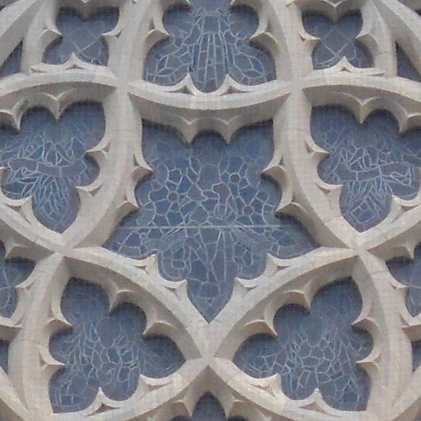 Detailed stone gothic window tracery design.