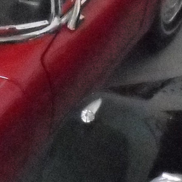 Close-up of a red vehicle with chrome details
