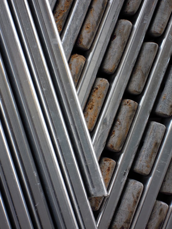 Close-up of rusty and clean metal rods pattern.
