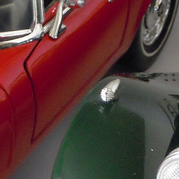 Close-up of a vintage car's red and green bodywork.