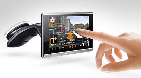 Finger touching Navigon 8410 GPS with city map display.